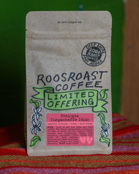 Roosroast Coffee package on a colorful fabric background