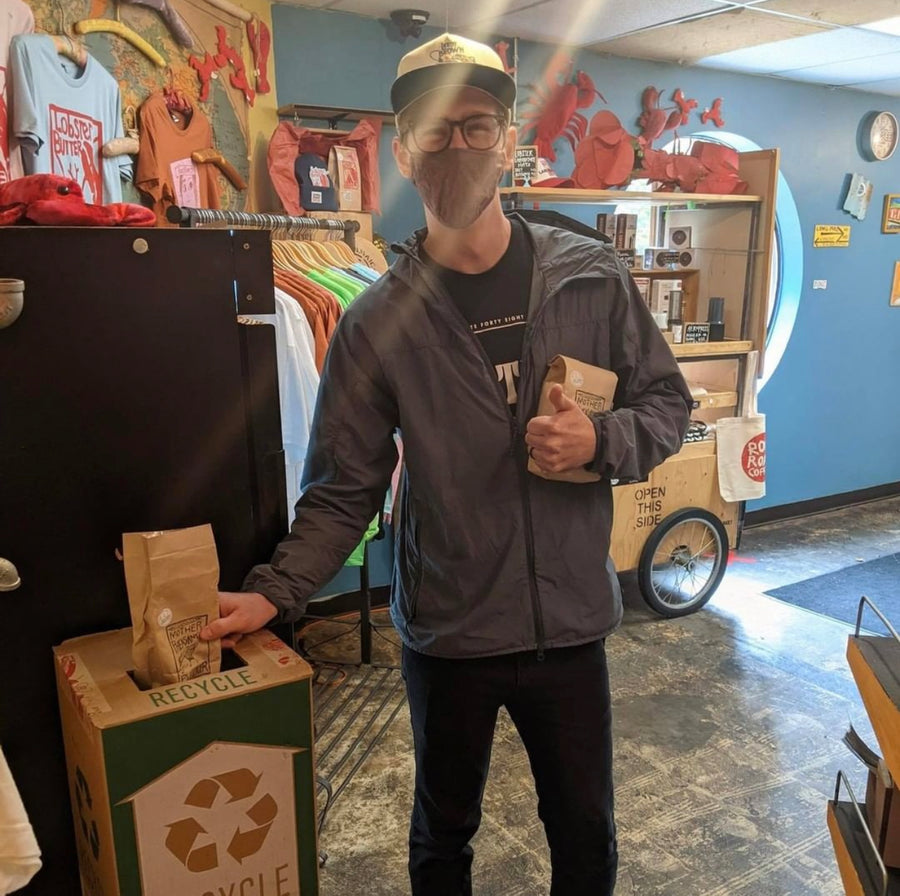 man recycling paper coffee bag