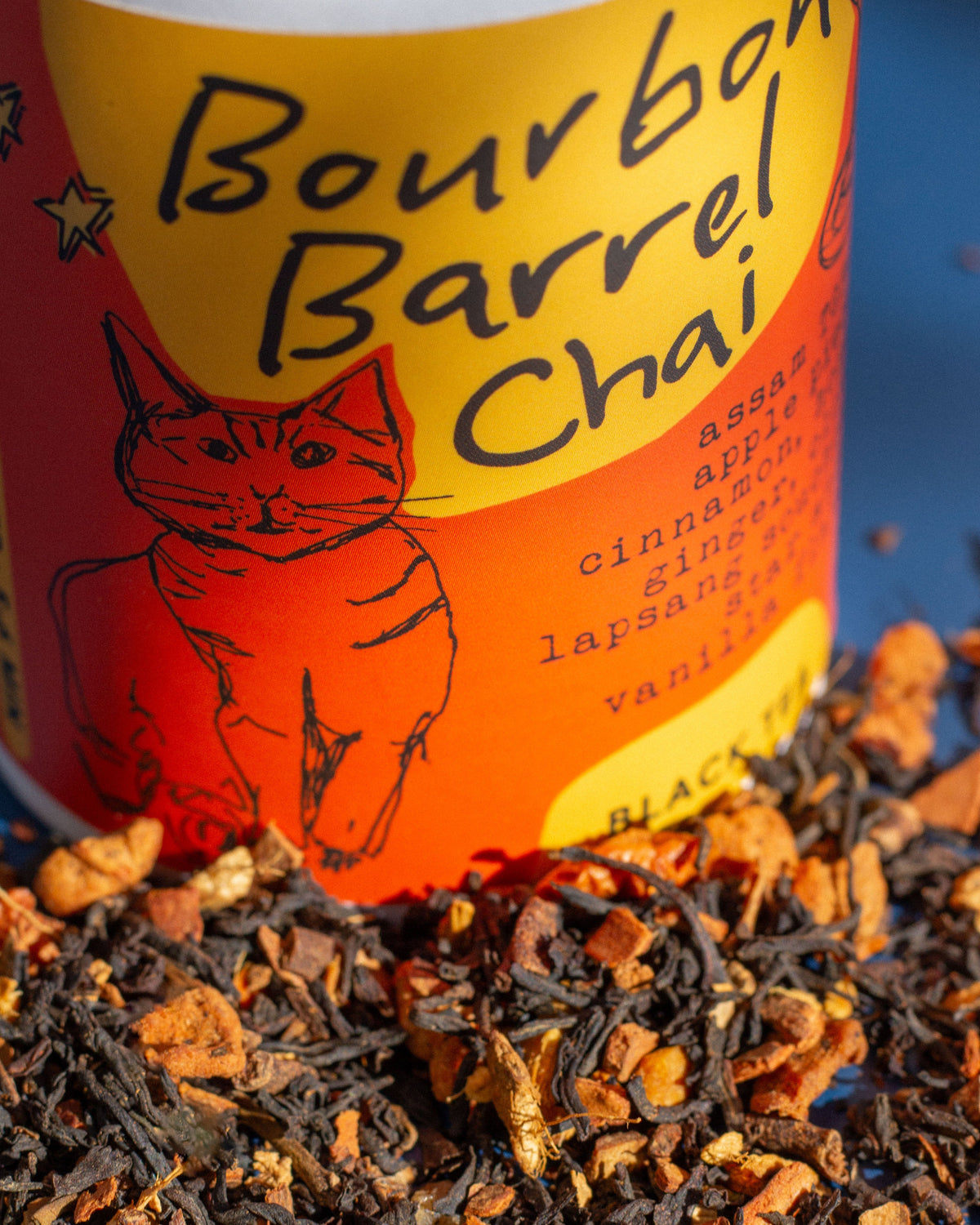 Bourbon Barrel Chai tea can with tea leaves in the foreground