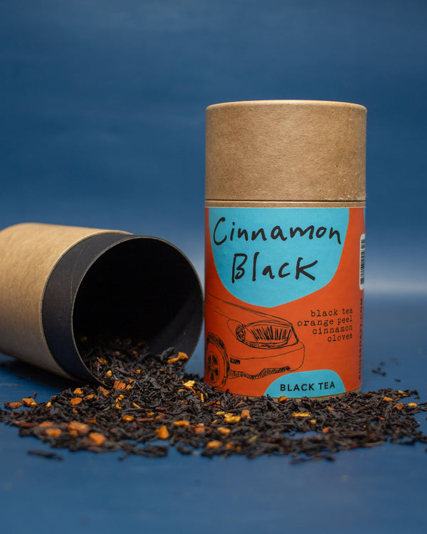 Cinnamon Black black tea packaging with loose tea on a blue background