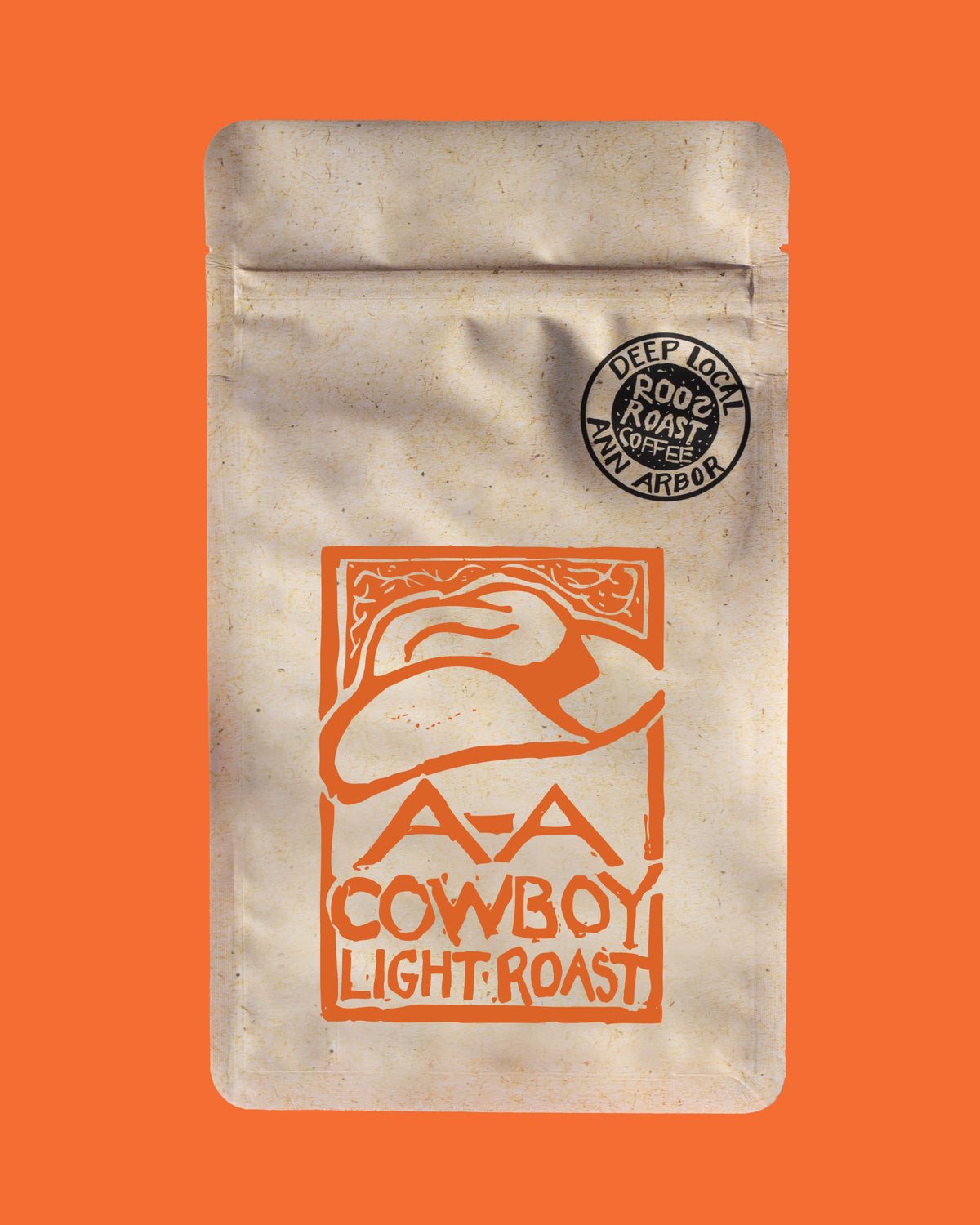 Coffee package with cowboy hat design and 'Cowboy Light Roast' text on an orange background