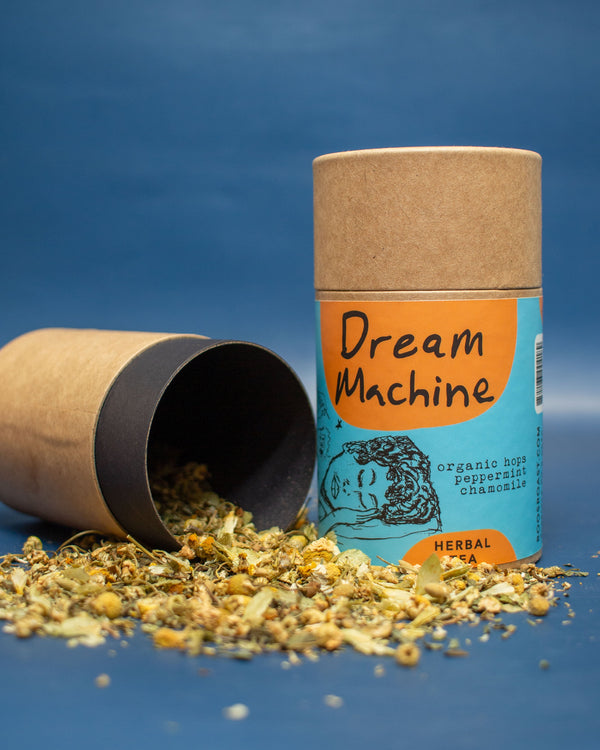 Herbal tea packaging with dried herbs on a blue background