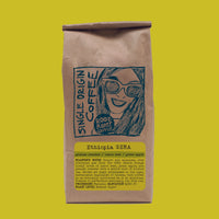 Brown coffee bag with a graphic of a woman and text on a bright yellow background
