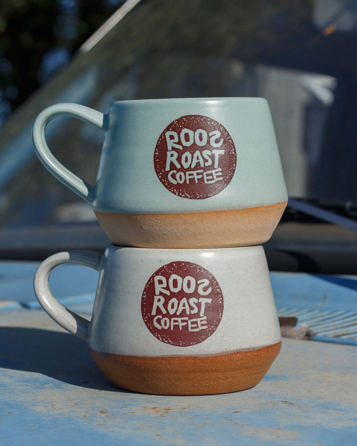 two mugs stacked one blue one white