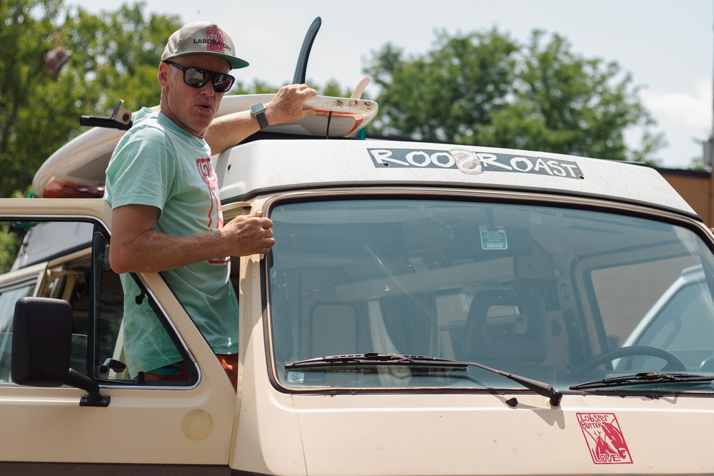john roos standing on his 1970s van