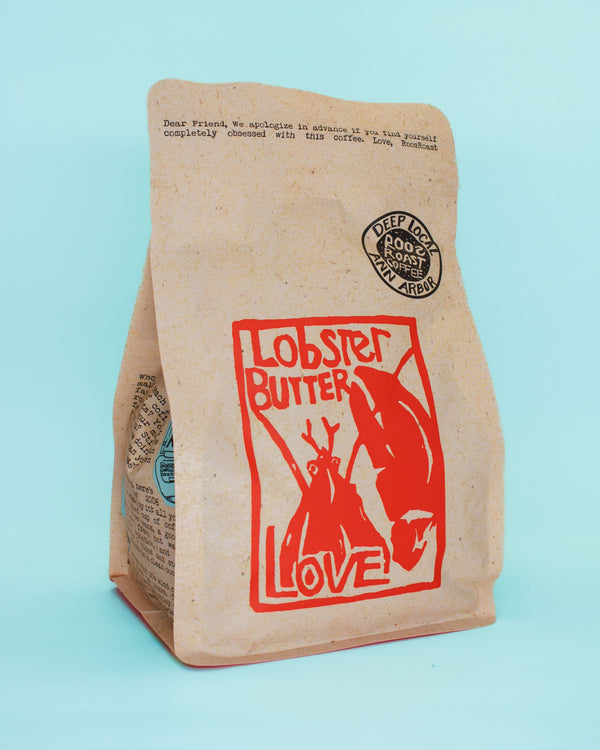 Kraft paper coffee bag with lobster and 'Lobster Butter Love' design on a light blue background