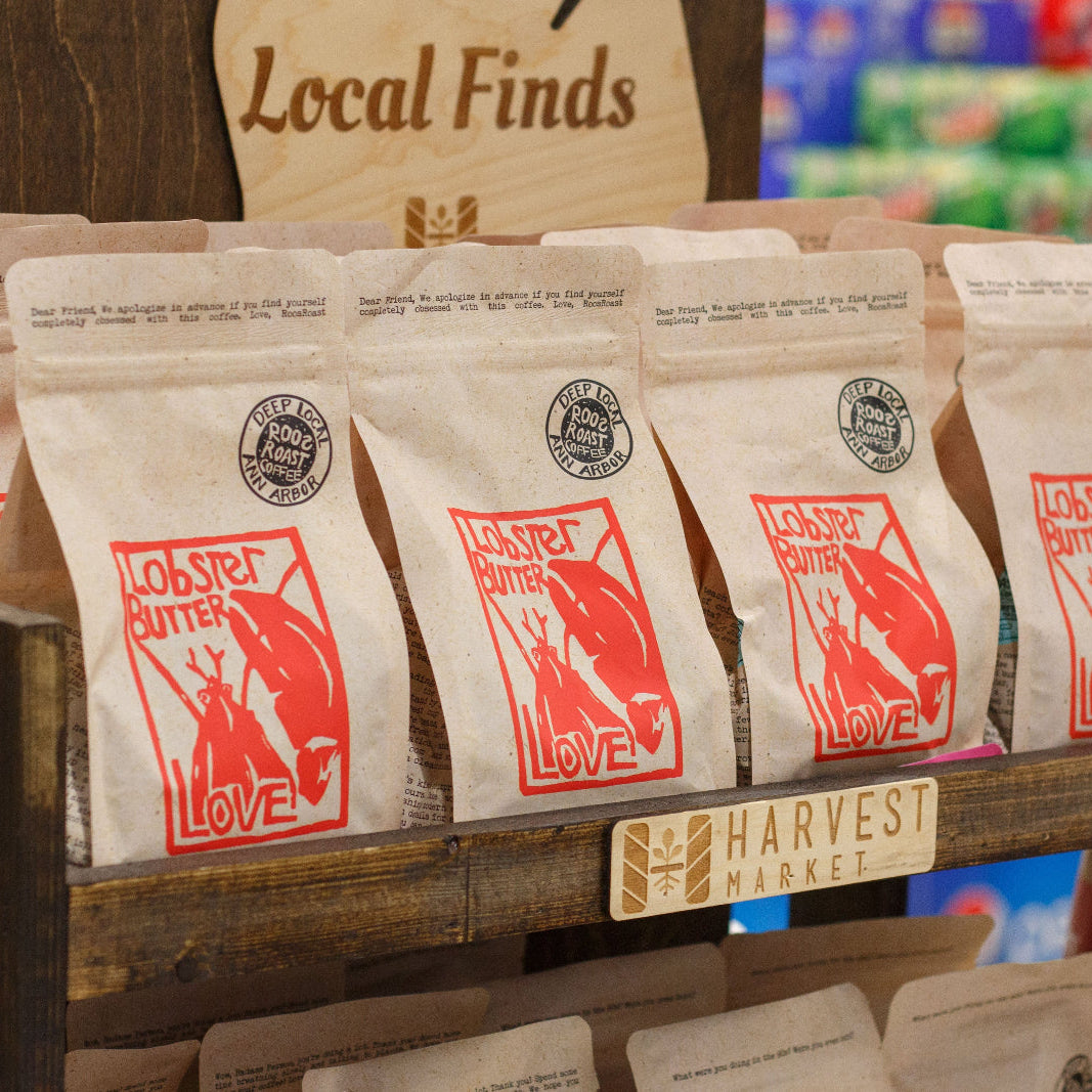 Row of 'Lobster Butter Love' product packages on a shelf with 'Harvest' branding.