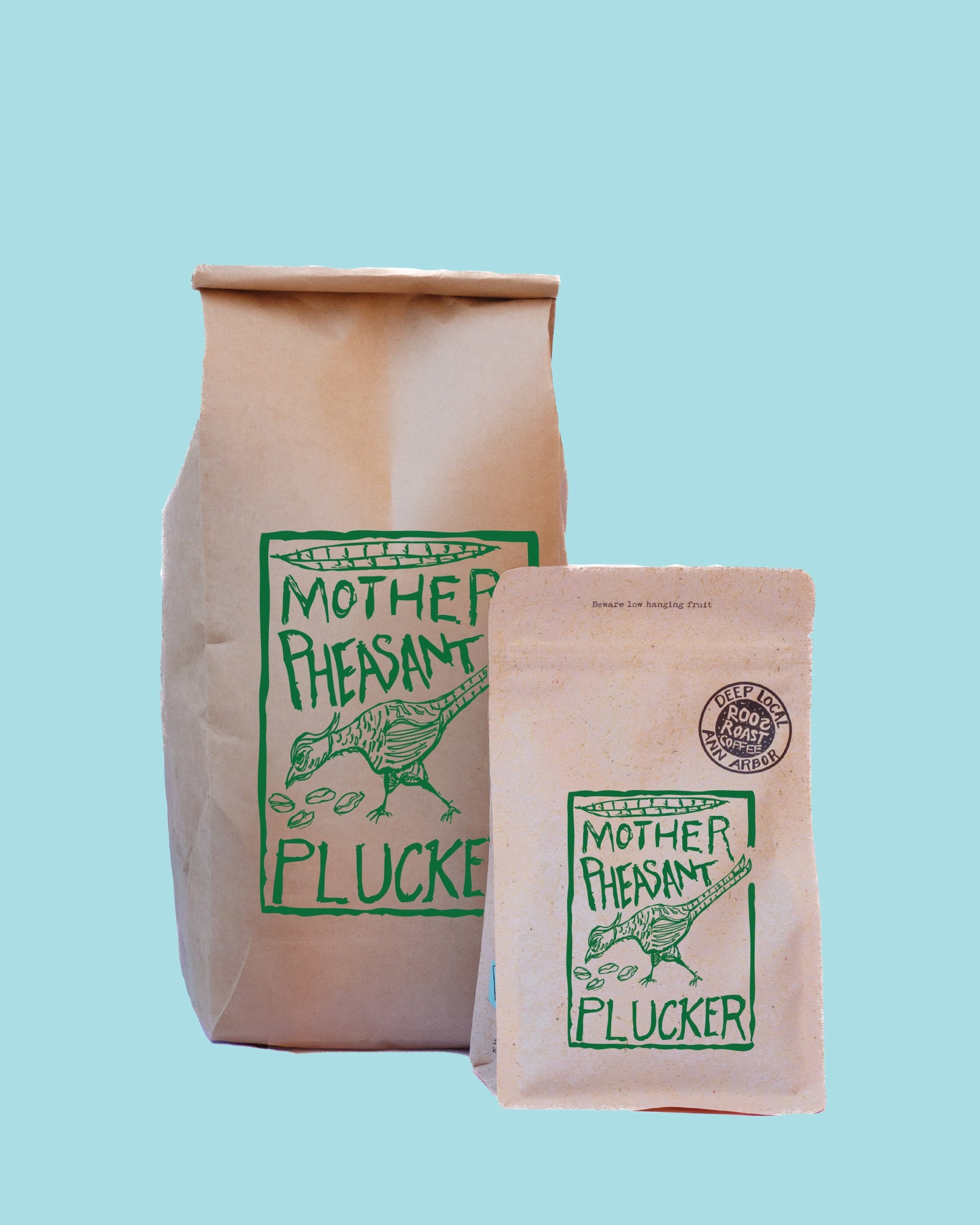 Two brown paper pouches of Mother Pheasant Plucker beef with green printed logos, shown against a solid light blue background.