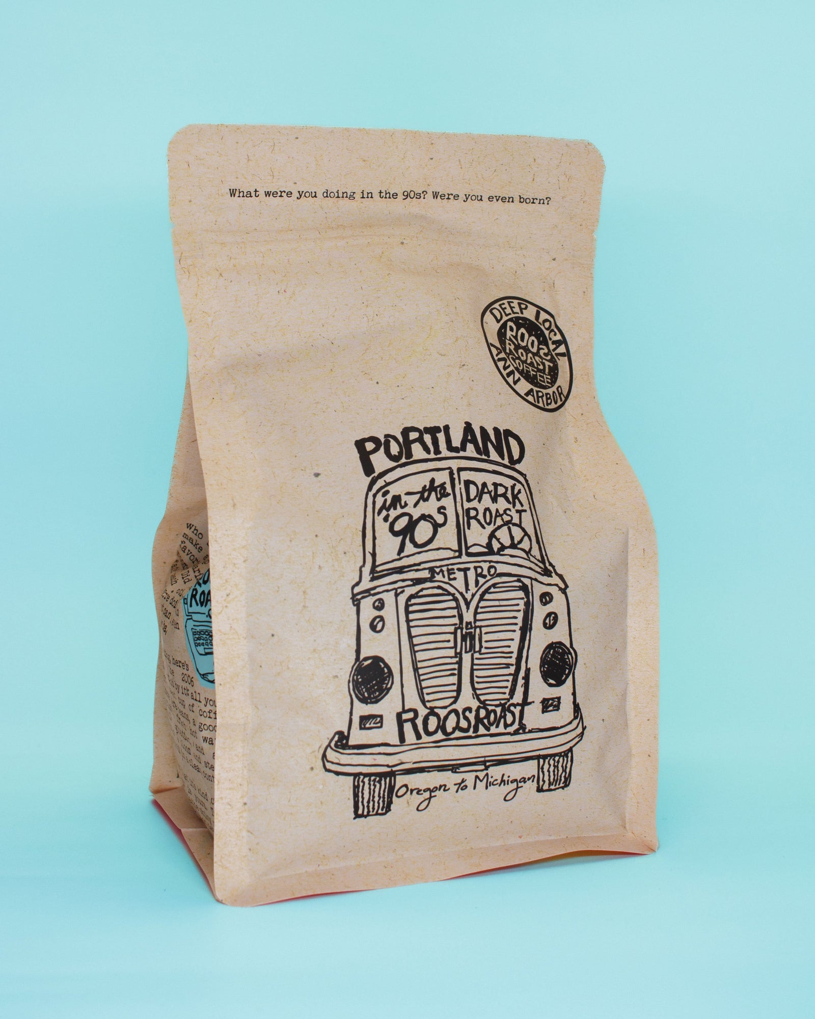 Kraft paper coffee bag with vintage truck graphic and text on a light blue background