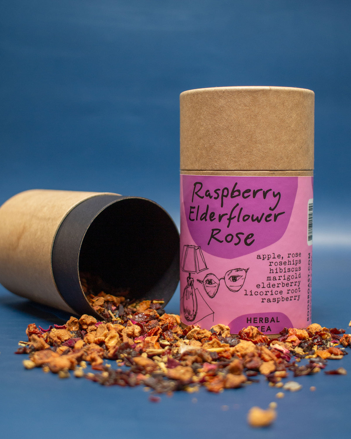 Herbal tea packaging with loose tea leaves on a blue background