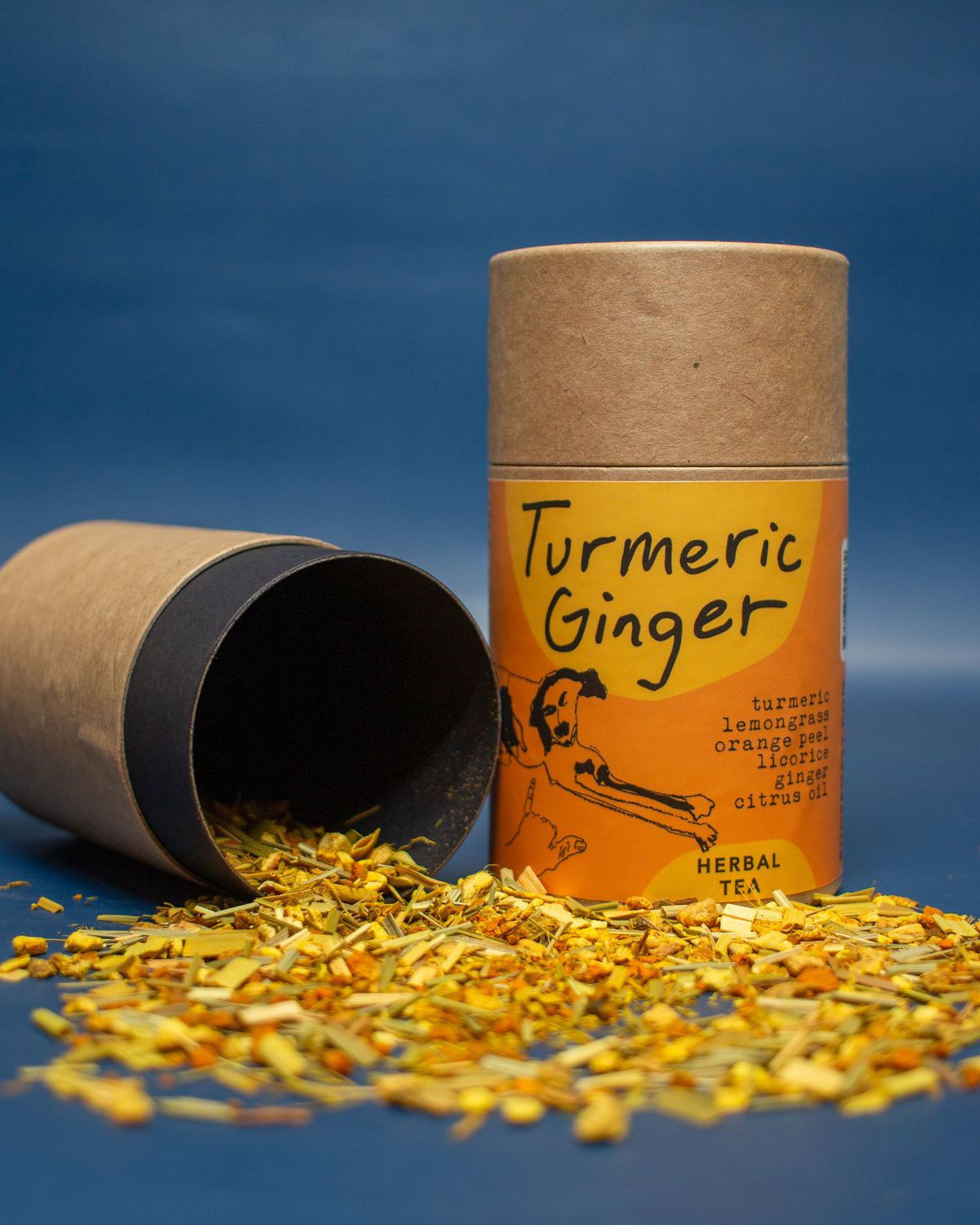 Turmeric Ginger herbal tea packaging with loose tea on a blue background