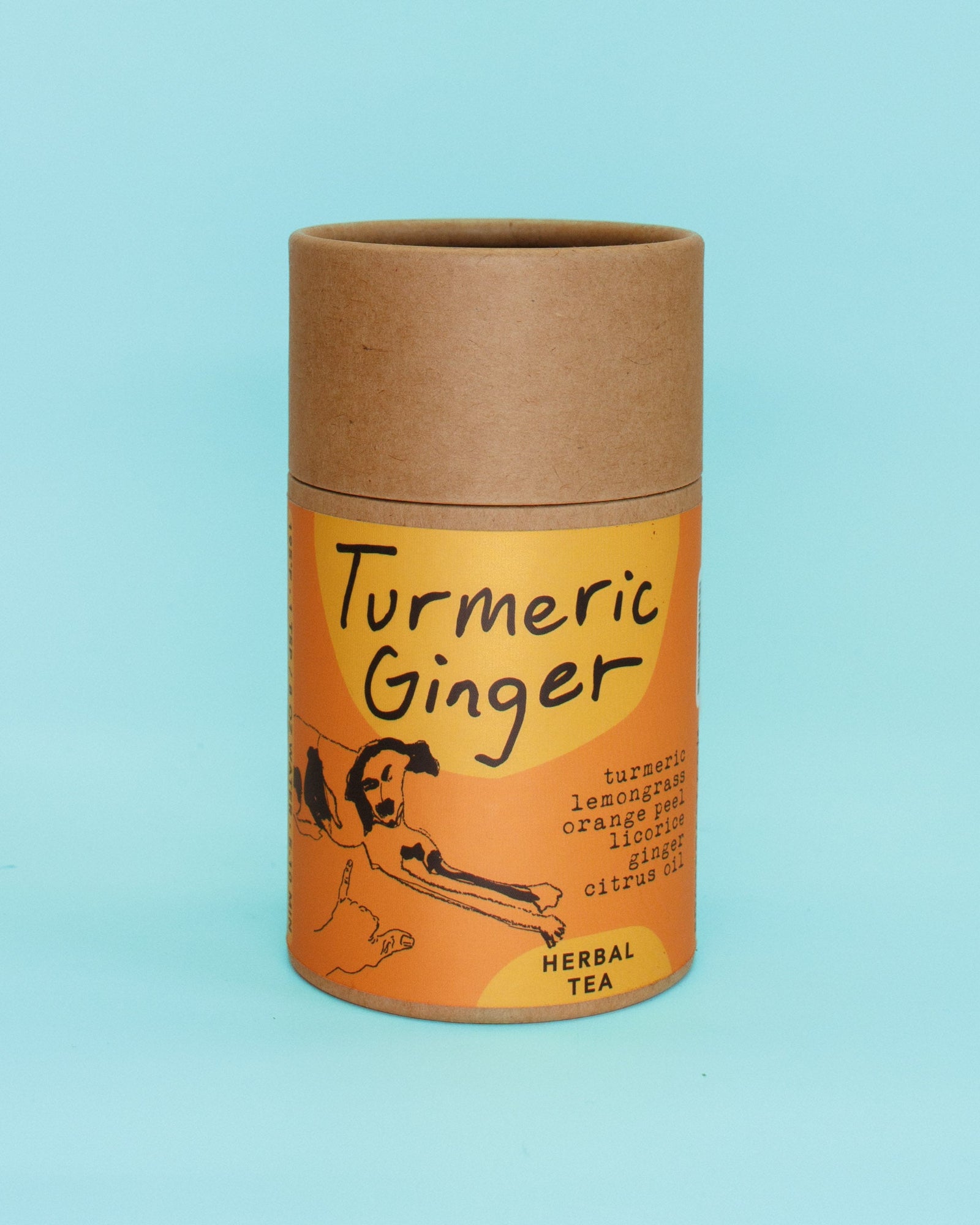 Cardboard container with 'Turmeric Ginger' herbal tea label on a light blue background